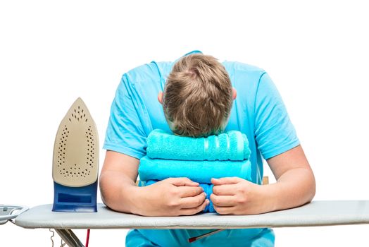 a very tired man fell asleep while ironing towels, a portrait is isolated