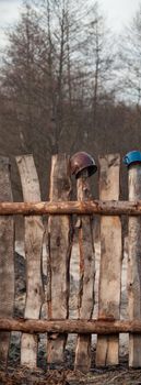 Old wooden boundary fence with nails on sunny day