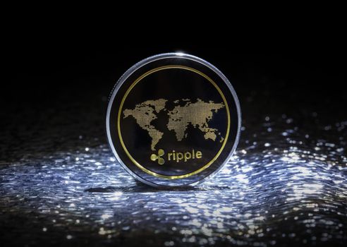 ripple crypto currency close-up on darkly shiny background