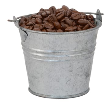 Dark roasted coffee beans in a miniature metal bucket, isolated on a white background