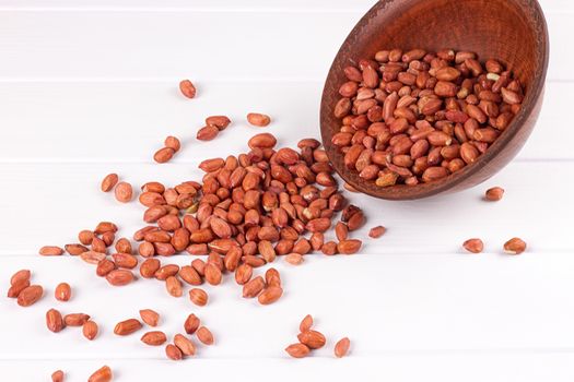Peanuts in a brown plate. on white background