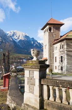 Cantacuzino Castle and the Carpathian Mountains in a sunny day. Residence and museum in a Transylvanian Busteni city, Romania