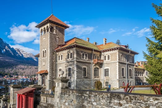 Cantacuzino Castle and the Carpathian Mountains in a sunny day. Residence and museum in a Transylvanian Busteni city, Romania