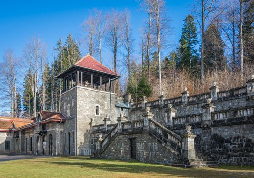 Cantacuzino Castle and the Carpathian Mountains in a sunny day. Residence and museum in a Transylvanian Busteni city, Romania