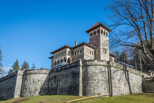 Cantacuzino Castle and the Carpathian Mountains in a sunny day. Residence and museum in a Transylvanian Busteni city, Romania