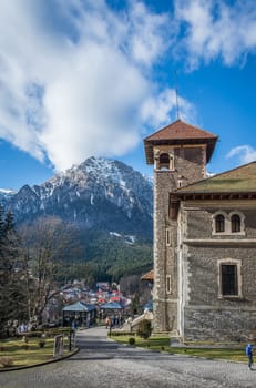 Cantacuzino Castle and the Carpathian Mountains in a sunny day. Residence and museum in a Transylvanian Busteni city, Romania