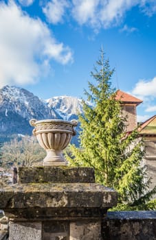 Cantacuzino Castle and the Carpathian Mountains in a sunny day. Residence and museum in a Transylvanian Busteni city, Romania