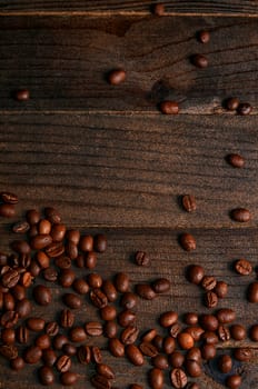 The coffee beans on a wooden background