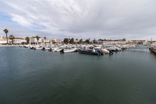 Wide view of Faro city docks with fishing and recreational boats.