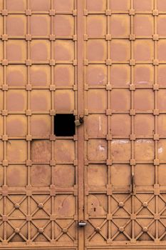 Close up view of a brown old rusty metal door.