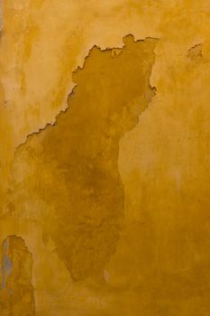 Close up view of an old texture yellow wall.