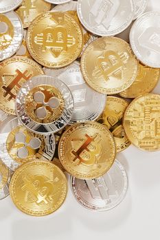 several aligned crypto currency coins on a white background.