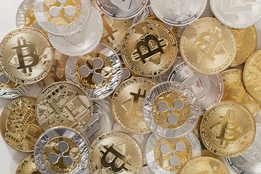 several aligned crypto currency coins on a white background.