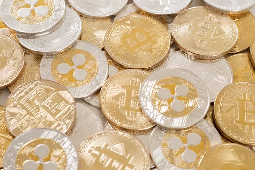 several aligned crypto currency coins on a white background.