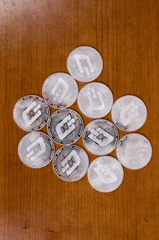 several aligned ripple coins on top of wooden table.