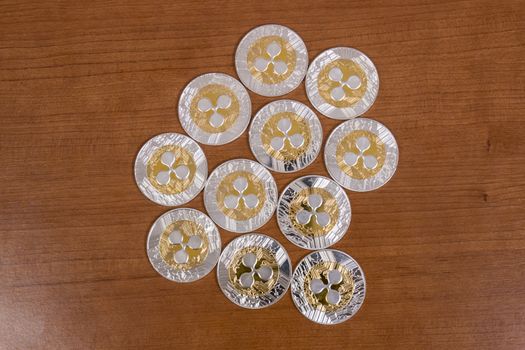 several aligned ripple coins on top of wooden table.