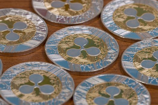 several aligned ripple coins on top of wooden table.