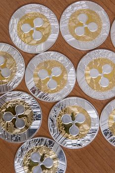 several aligned ripple coins on top of wooden table.