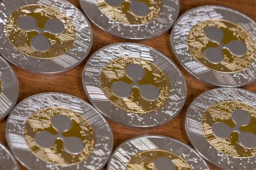 several aligned ripple coins on top of wooden table.