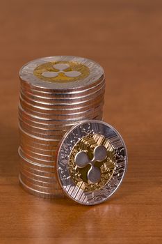 several aligned ripple coins on top of wooden table.