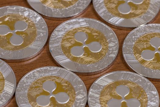 several aligned ripple coins on top of wooden table.