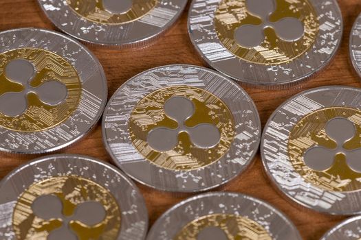 several aligned ripple coins on top of wooden table.