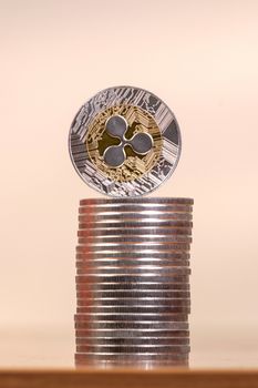 several aligned ripple coins on top of wooden table.