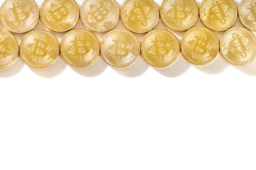 Shiny golden bitcoins on a white background.