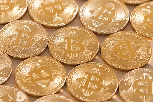Shiny golden bitcoins on a white background.