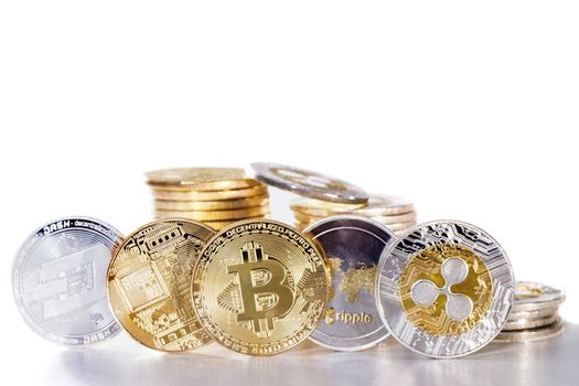 Shiny crypto currency coins on a white background.