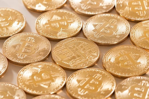 Shiny golden bitcoins on a white background.