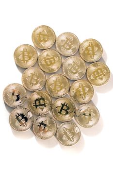 Shiny golden bitcoins on a white background.