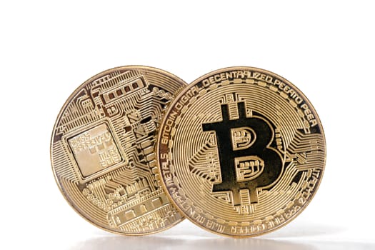 Shiny golden bitcoins on a white background.