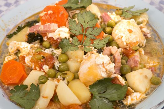 Traditional portuguese culinary meal of green peas with egg, potatoes and carrots.