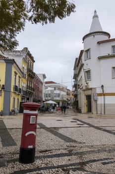 Tourist area downtown of Faro city with cobblestone streets and stores.