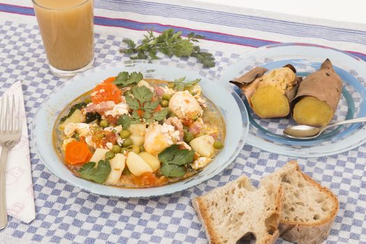 Traditional portuguese culinary meal of green peas with egg, potatoes and carrots.