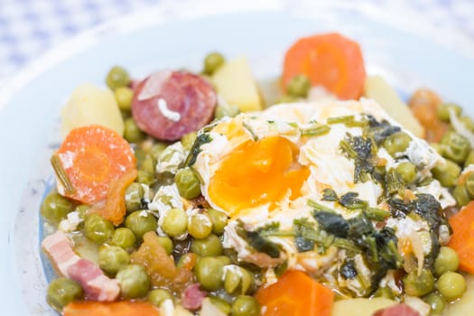 Traditional portuguese culinary meal of green peas with egg, potatoes and carrots.