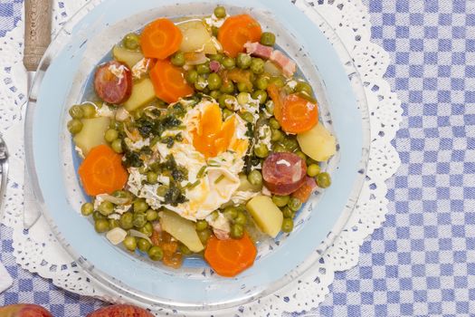 Traditional portuguese culinary meal of green peas with egg, potatoes and carrots.