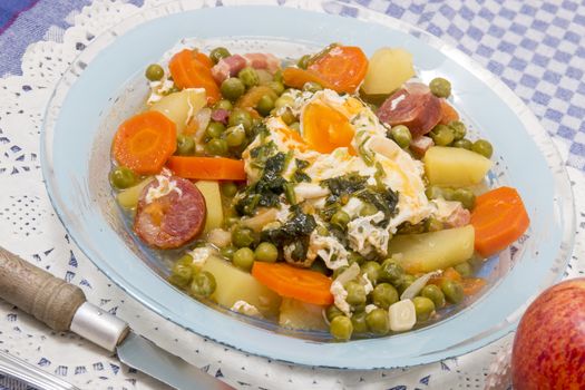 Traditional portuguese culinary meal of green peas with egg, potatoes and carrots.