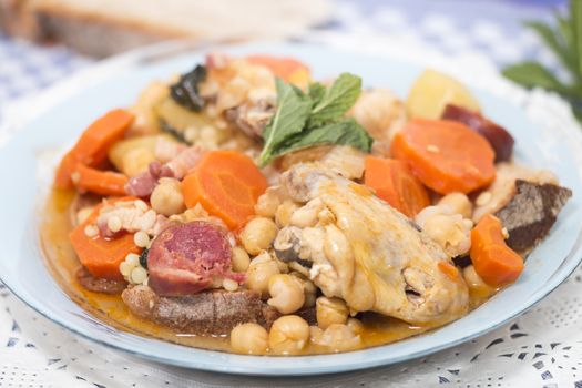 Traditional portuguese meal of Chickpeas with chicken, carrot and chorizo.