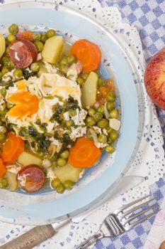 Traditional portuguese culinary meal of green peas with egg, potatoes and carrots.