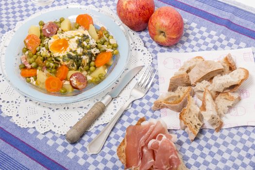 Traditional portuguese culinary meal of green peas with egg, potatoes and carrots.