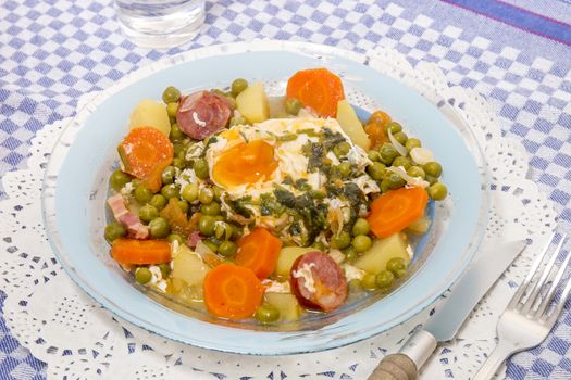 Traditional portuguese culinary meal of green peas with egg, potatoes and carrots.