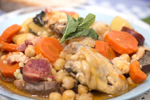 Traditional portuguese meal of Chickpeas with chicken, carrot and chorizo.