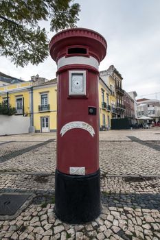 traditional red letter mail box located in Faro city, Portugal.