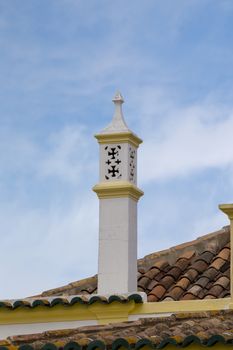 Typical chimney on brown tile roofs in Portuguese architecture.