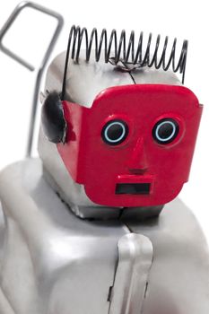 Vintage retro red face tin toy robot isolated on a white background.