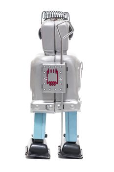 Vintage retro red face tin toy robot isolated on a white background.