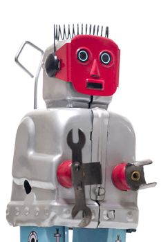 Vintage retro red face tin toy robot isolated on a white background.