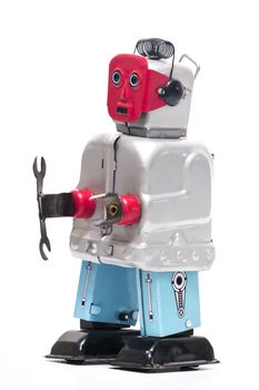 Vintage retro red face tin toy robot isolated on a white background.